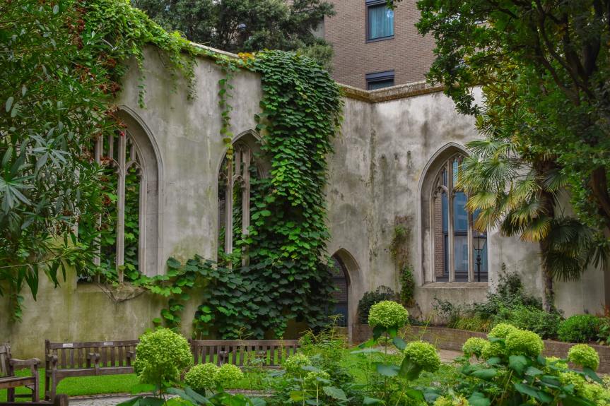 A stone church courtyard draped in lush vegetation